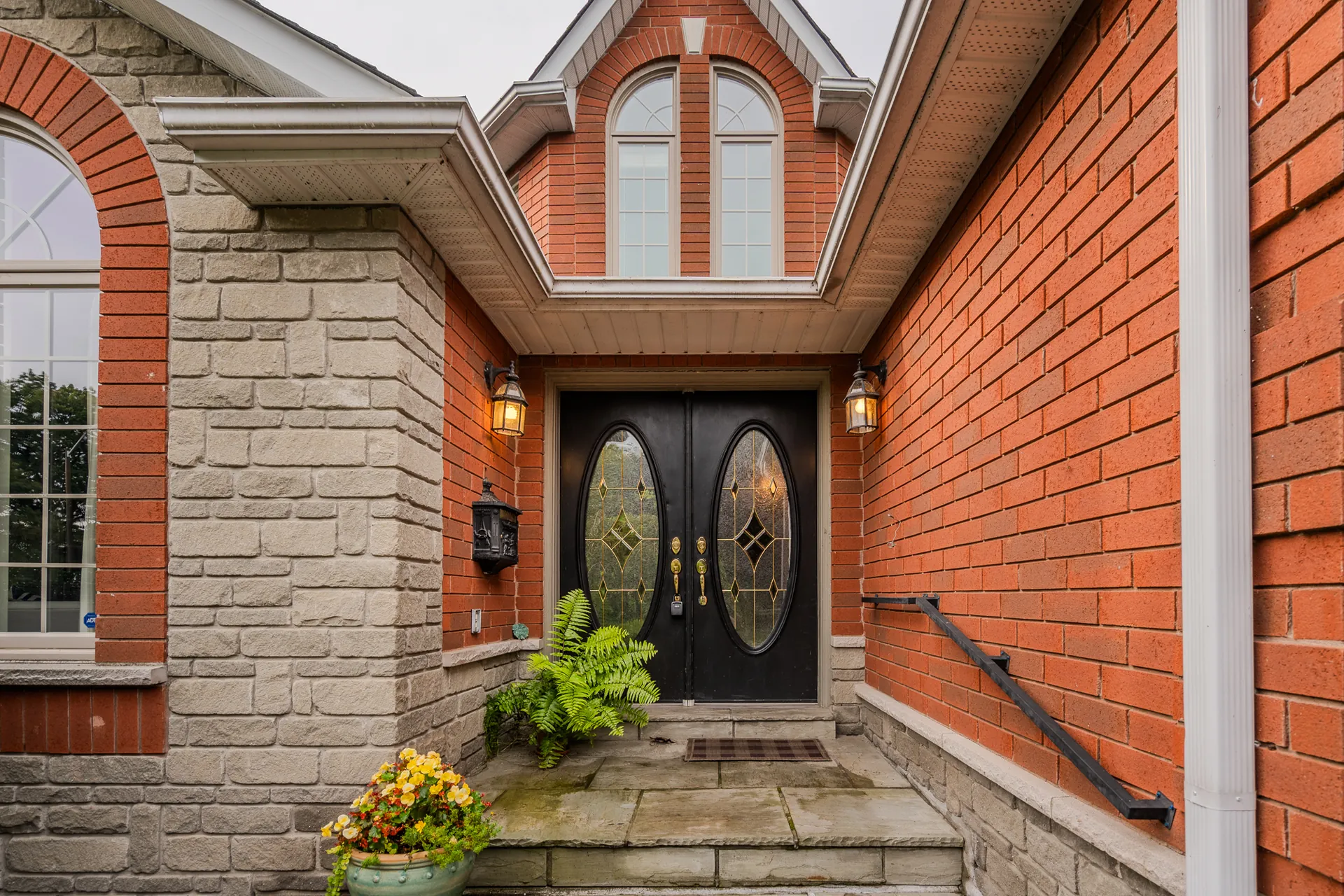 Front entrance with double doors, brick and stone surround